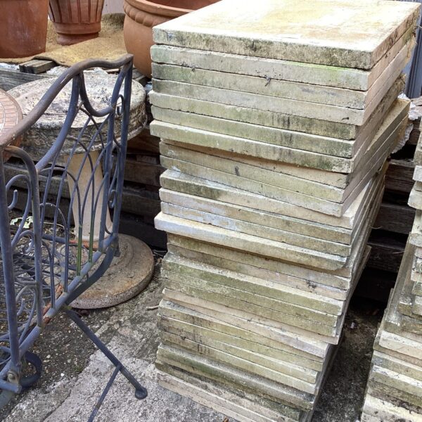 Stack of weathered concrete paving slabs for garden use.
