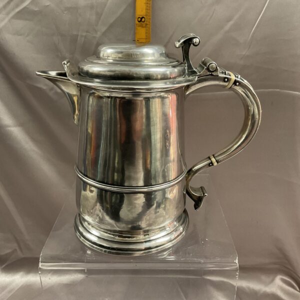 Antique Georgian silver lidded tankard with ornate handle.