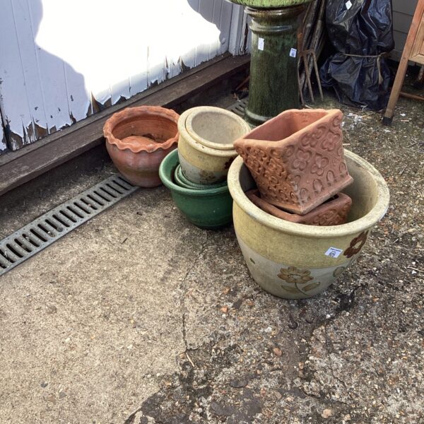Assortment of vintage garden pots and planters in various colours.