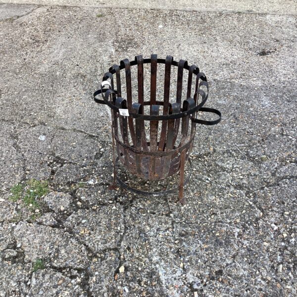 Rustic metal garden fire pit for outdoor heating and ambiance.
