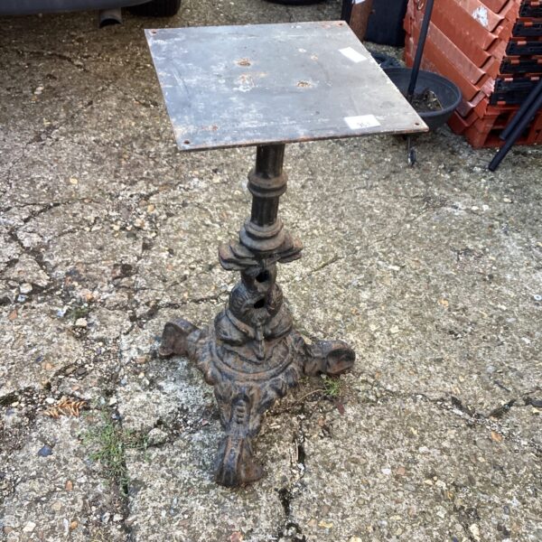 Ornate Victorian cast iron garden table base with weathered finish.