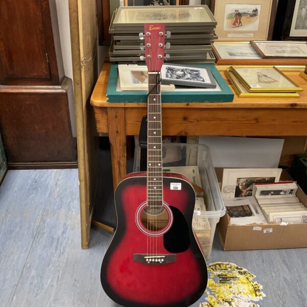 Dark burgundy Encore EWP-100 acoustic guitar, six string instrument.