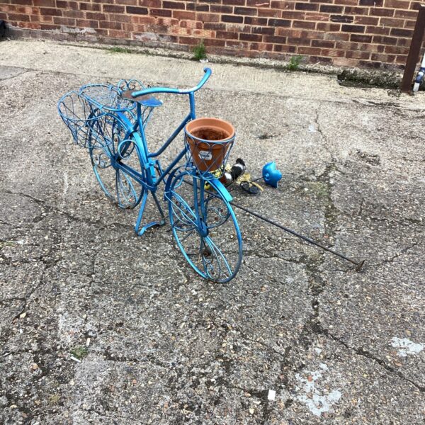 Vintage metal garden bike planter with flowers.
