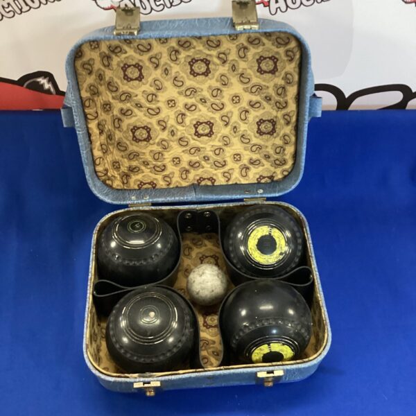 Vintage garden bowls set in a blue bag for outdoor games.