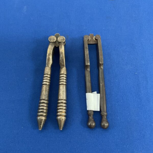 Antique nutcrackers with decorative handles, vintage kitchen tool.