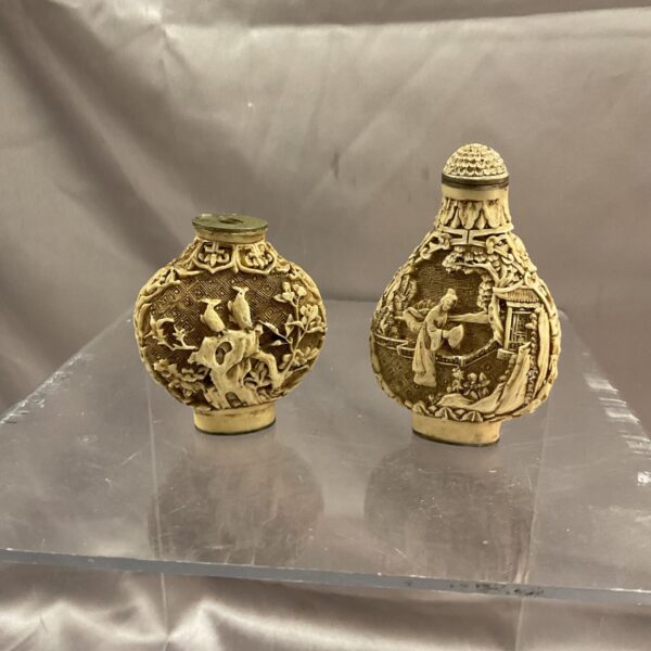 Intricate carving on antique oriental bone scent bottle.