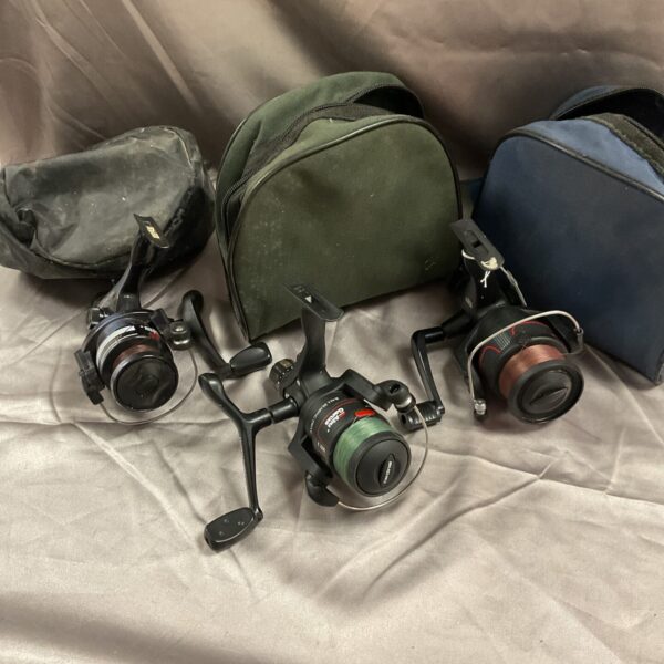 Vintage Abu Garcia fixed spool reels in a tackle bag.