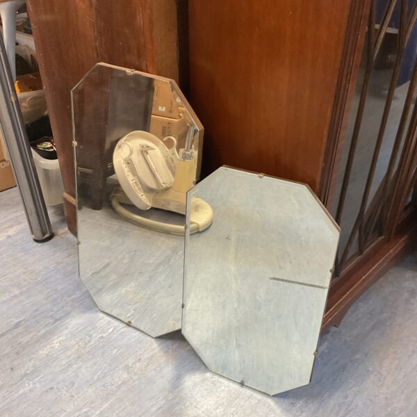 Pair of vintage bevelled mirrors with simple design.