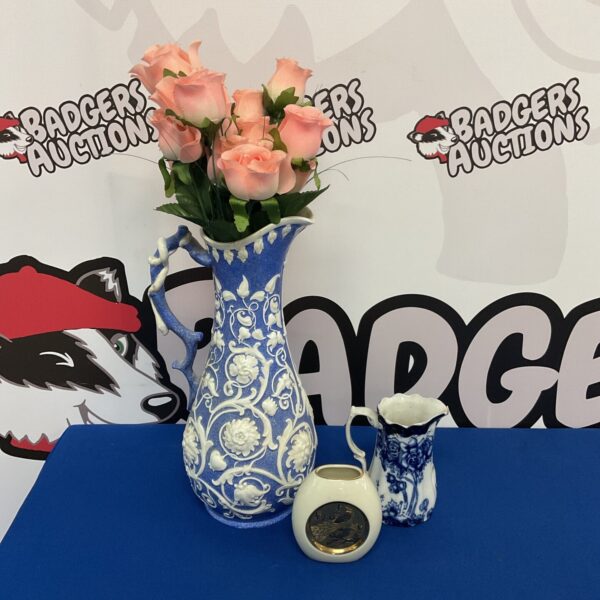 Antique blue and white ceramic ewer with floral design.