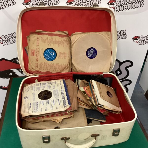 Vintage suitcase filled with a mixed lot of vinyl records.