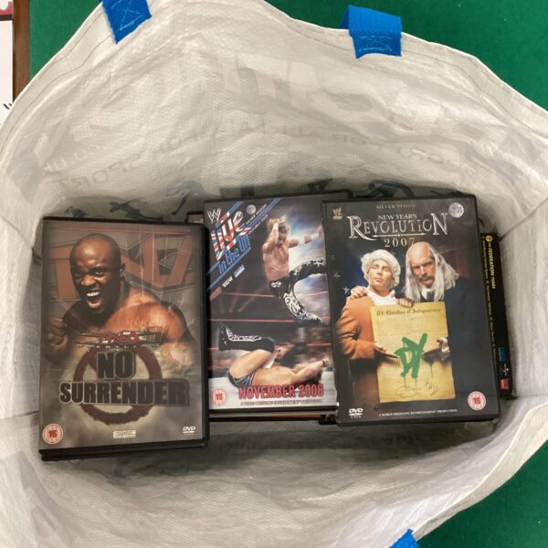Lot of WWE wrestling DVDs for collectors and fans.