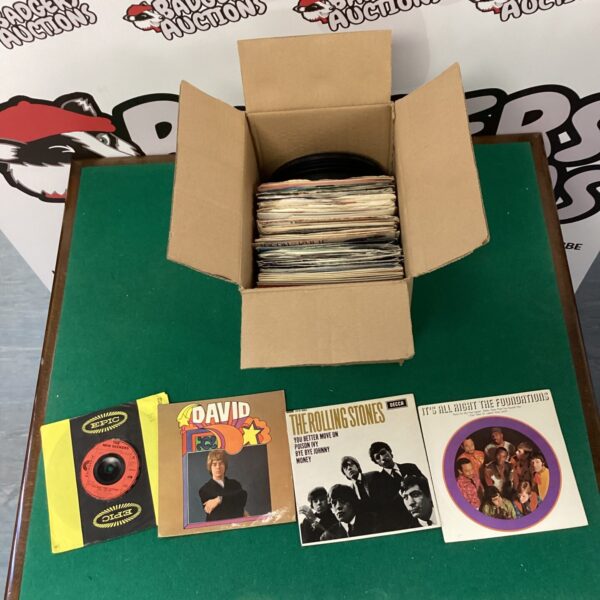 Box of mixed vinyl records for collectors and music enthusiasts.
