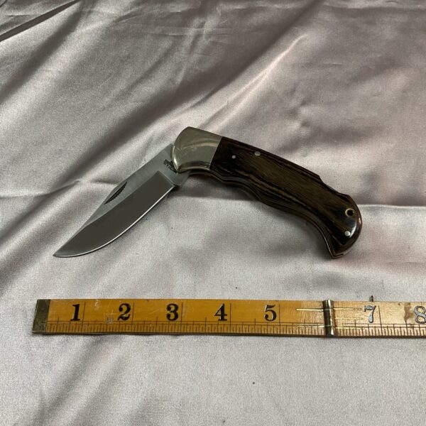 Vintage Whitby lock knife with dark handle and steel blade.