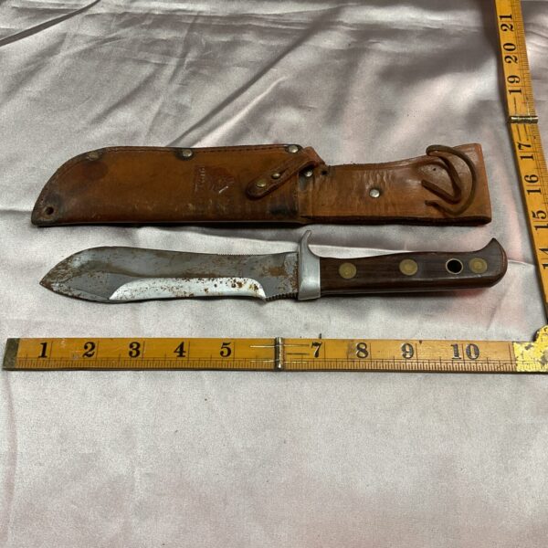 Vintage Puma sheath knife with leather sheath, classic German hunting tool.