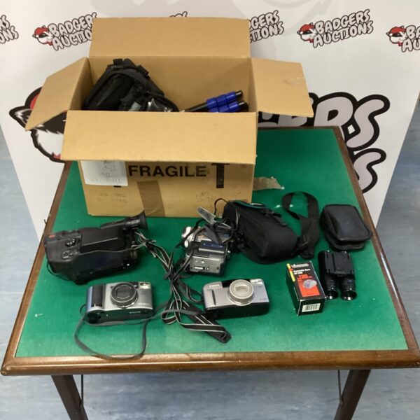 Assorted vintage cameras, camcorders, and tripods in a box.