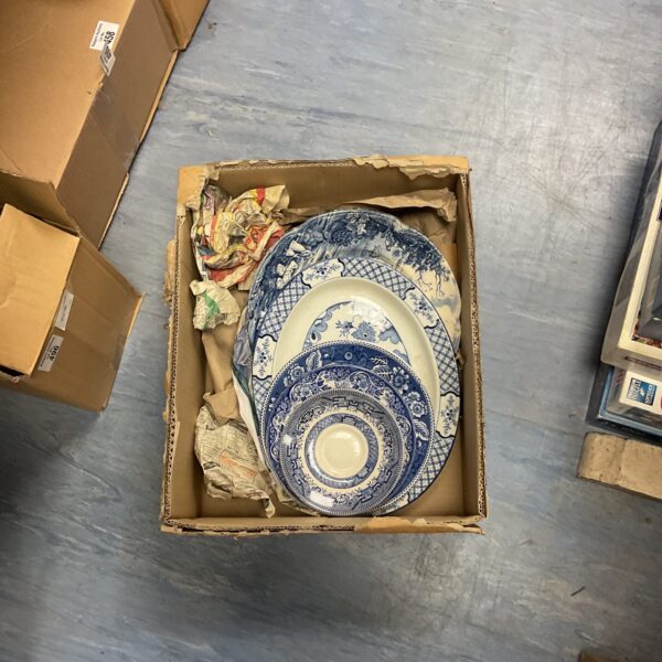 Vintage blue and white china plates arranged in a stack.