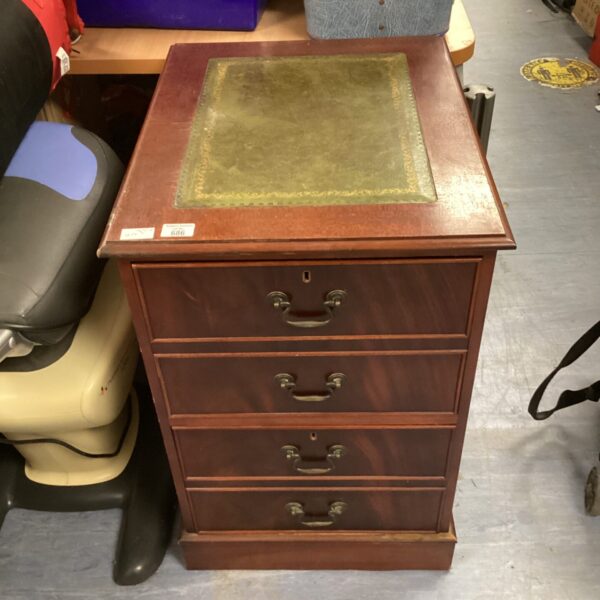Vintage wooden filing cabinet with leather top for office storage.
