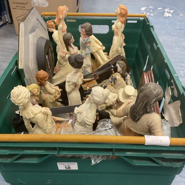 Tray of mixed vintage collectible figures for display.