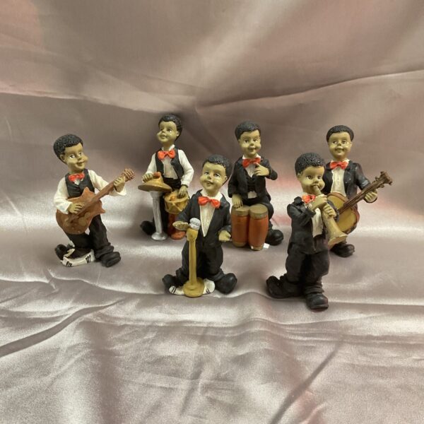 Group of four vintage New Orleans jazz band figurines.
