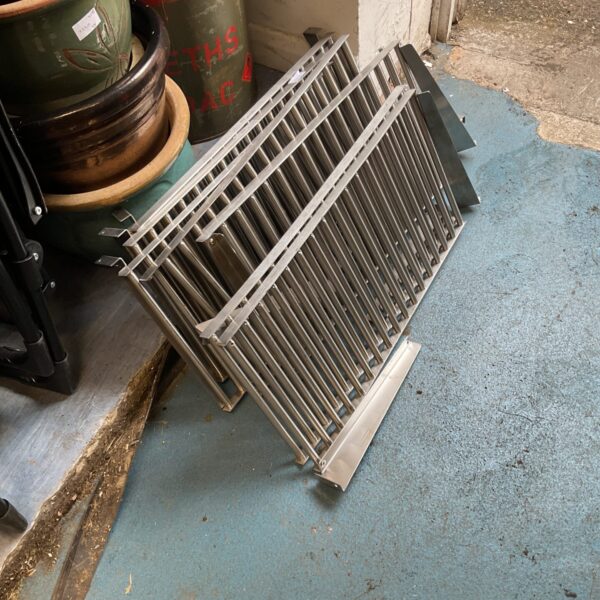 Stainless steel catering shelves for kitchen storage.