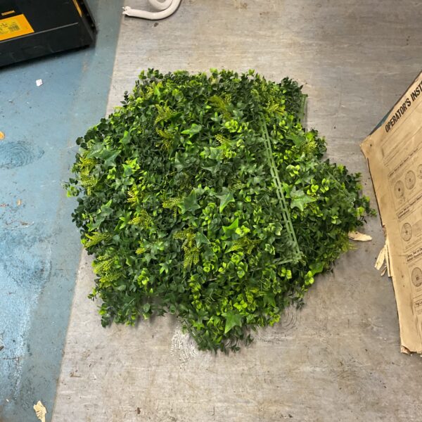 Dense garden privacy netting with artificial ivy foliage.