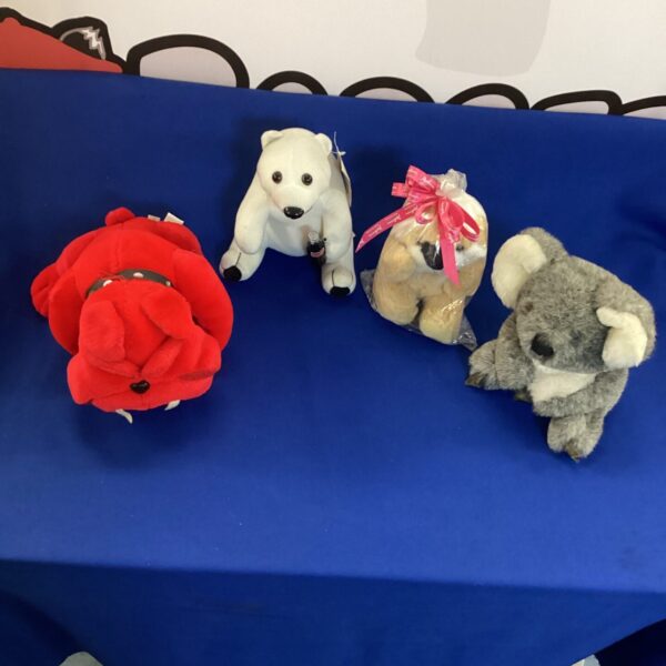 Teddy bear lot featuring Coca Cola polar bear and other plush toys.