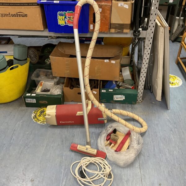 Vintage Electrolux Model V vacuum cleaner with attachments.