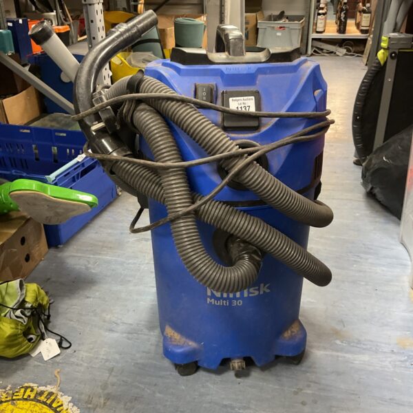 Blue Nilfisk Multi 30 industrial vacuum cleaner with hose attached.