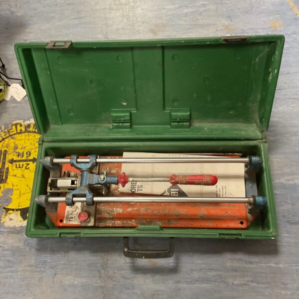 Vintage yellow case containing a professional tile cutter.