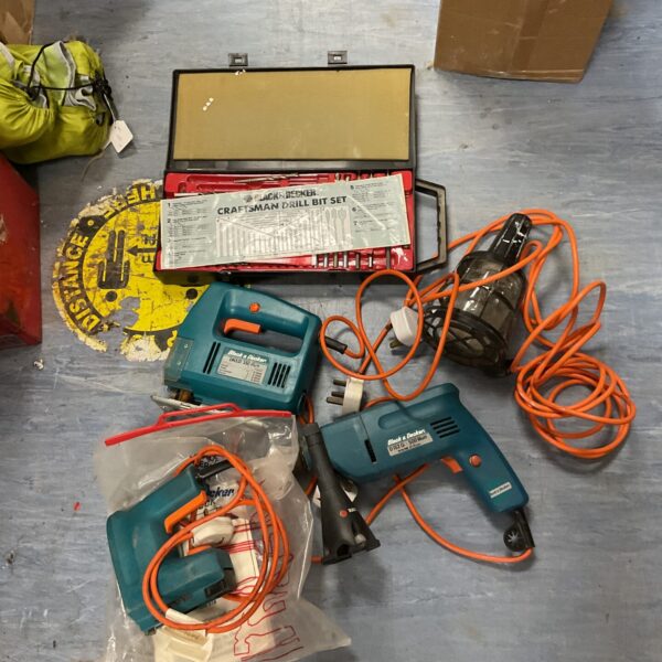 Vintage Black and Decker tool lot with drill, jigsaw, and staple gun.