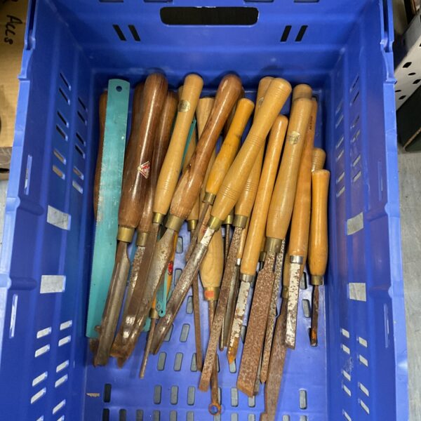 Vintage wood turning tools and chisels with wooden handles.