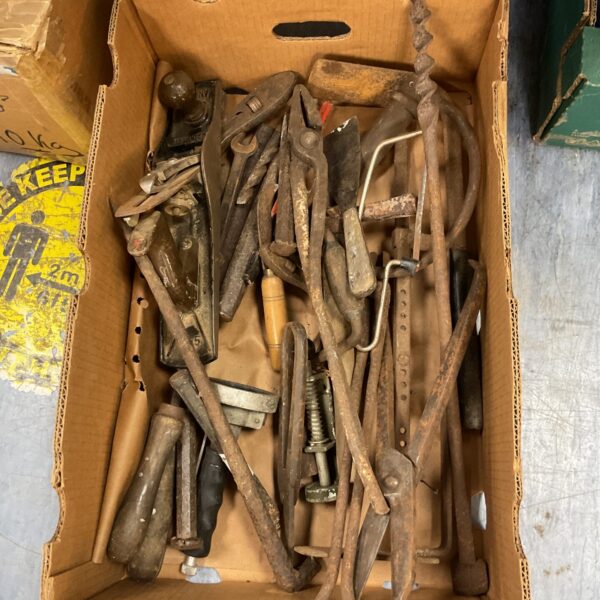 Assorted vintage woodworking tools in a tray, antique carpentry collection.