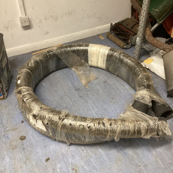 Dark industrial tubing roll, tightly wound and ready for use.