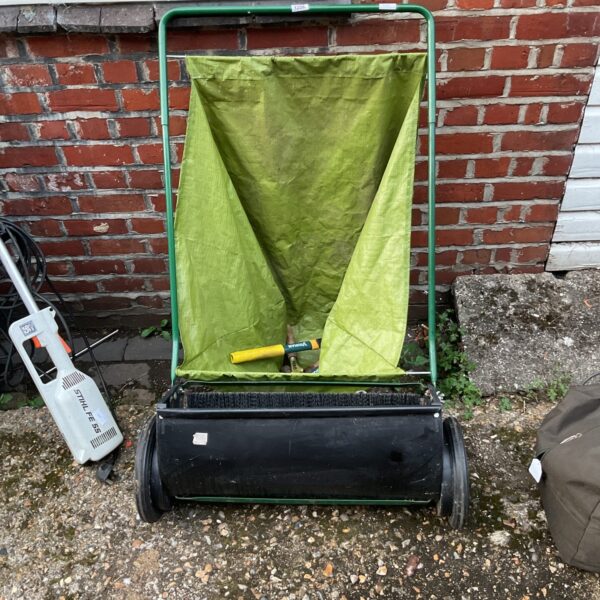Vintage garden leaf collector with attached bag and tools.