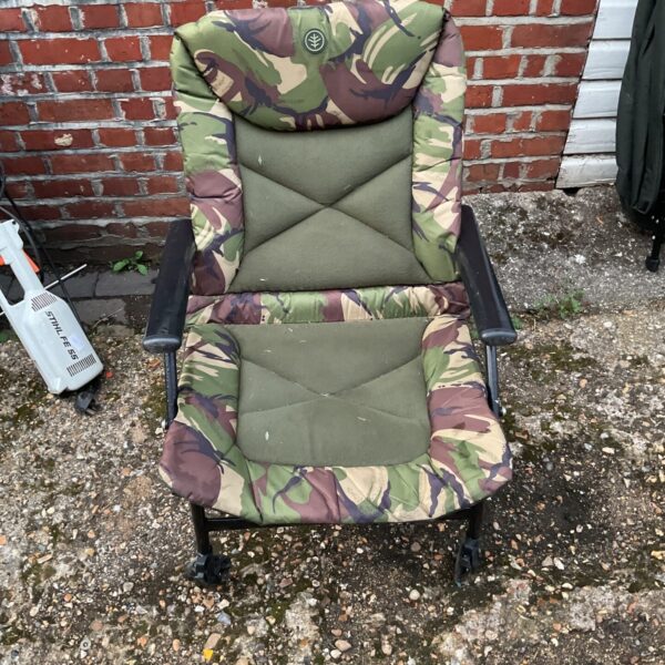Forest camouflage fishing chair, angling seat for outdoor use.