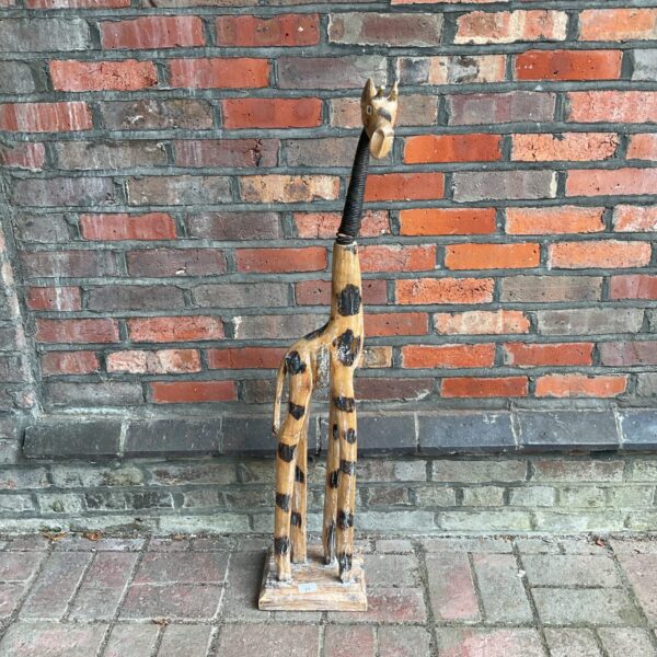 Large carved wooden giraffe with spring neck design.