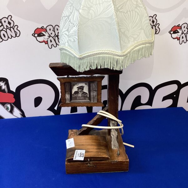 Vintage Jamaica Inn table lamp with fabric shade and wooden base.