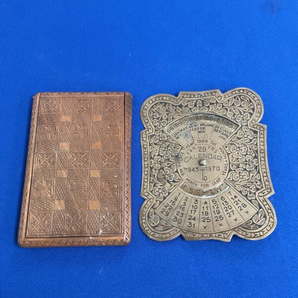 Intricate vintage carved wooden 28-year calendar with floral details.