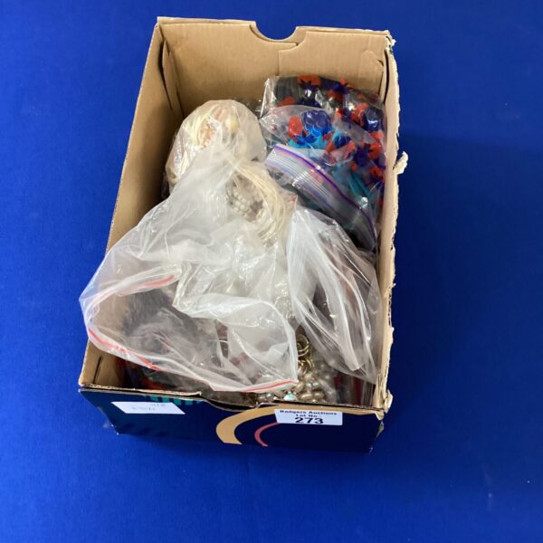 Assortment of colourful costume jewellery pieces in a box.