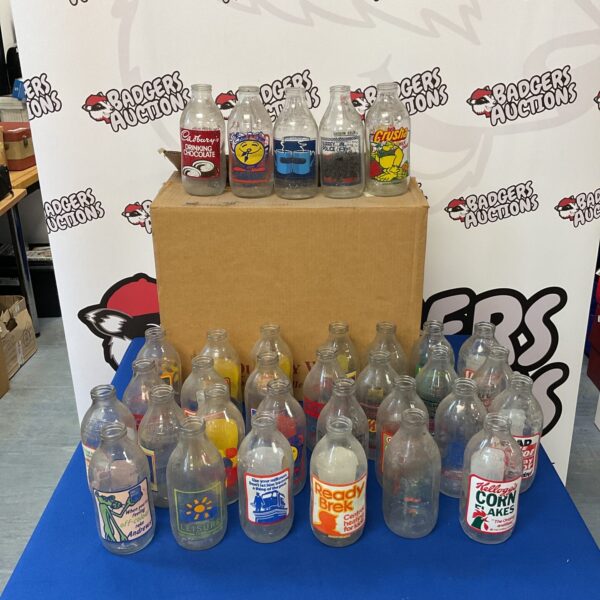 Collection of vintage branded milk bottles for collectors.