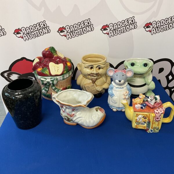 Vintage biscuit barrel collection with teapot and vases.
