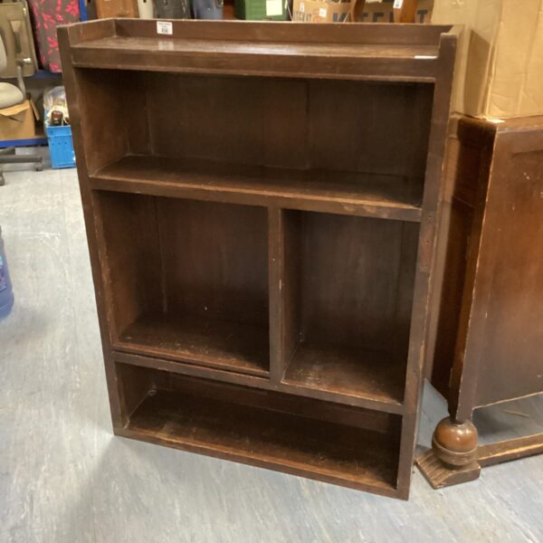 Vintage dark wood book shelf with classic design.