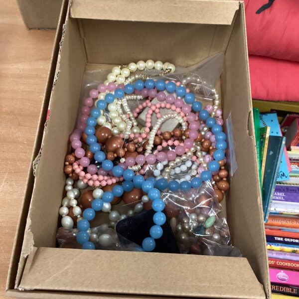 Costume jewellery lot with colourful beaded necklaces on display.