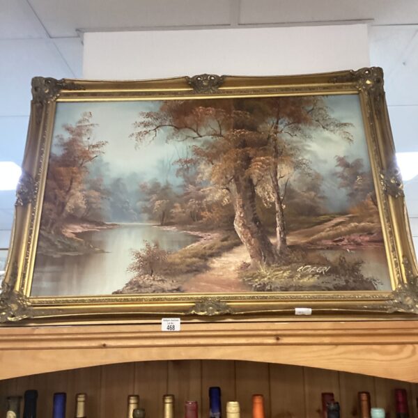 Large gilt framed river landscape painting with forest scene.
