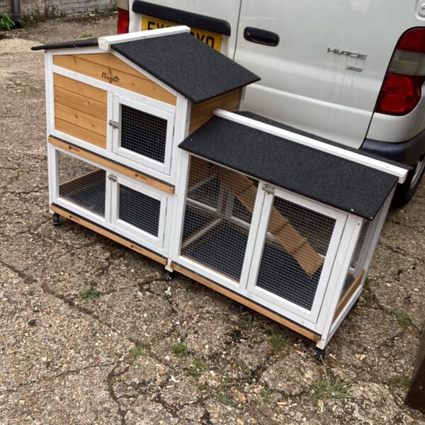 Small animal house with wire mesh and wooden panels.