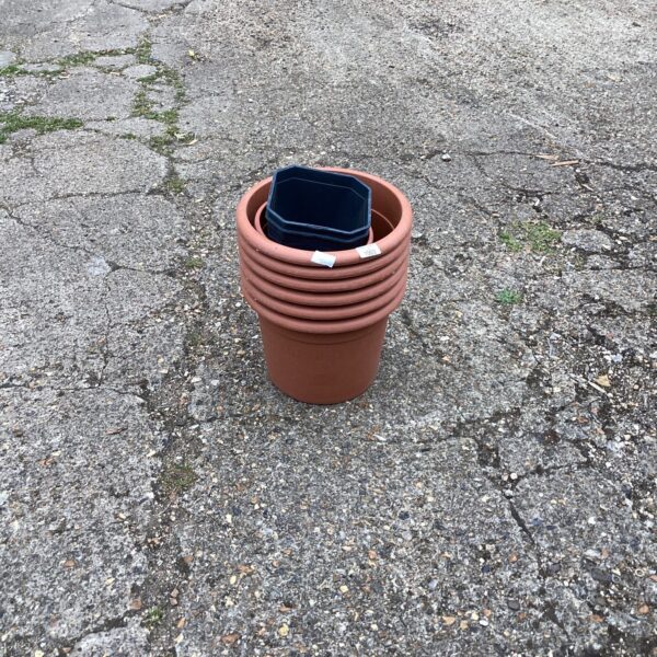 Lot of durable plastic garden planters for outdoor use.