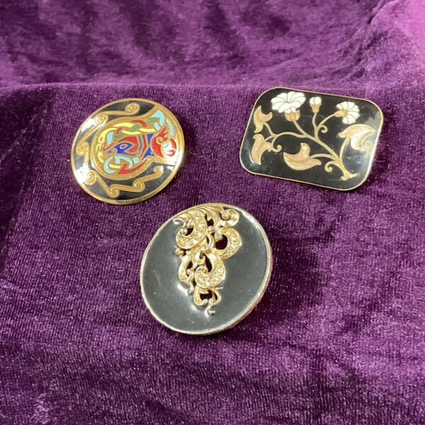 Vintage enamel brooch set with Art Deco designs.