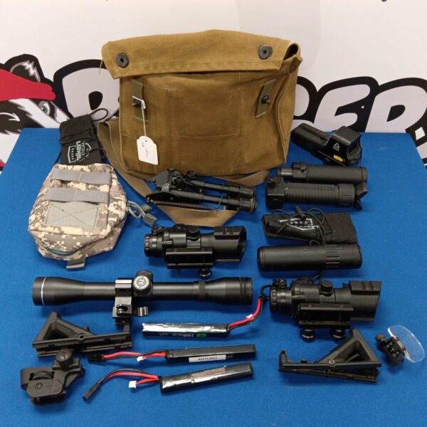 Canvas bag filled with vintage rifle scopes and accessories.