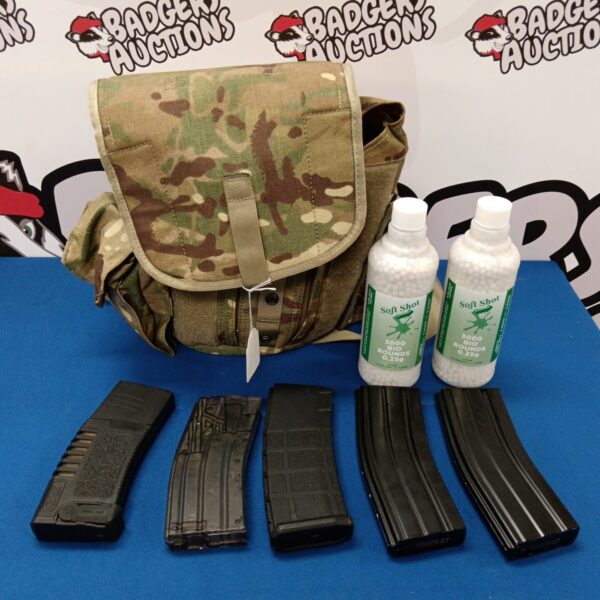 Airsoft kit with camo bag and magazines for outdoor games.