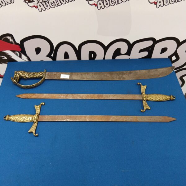 Lot of three vintage wall hanging swords with ornate detailing.